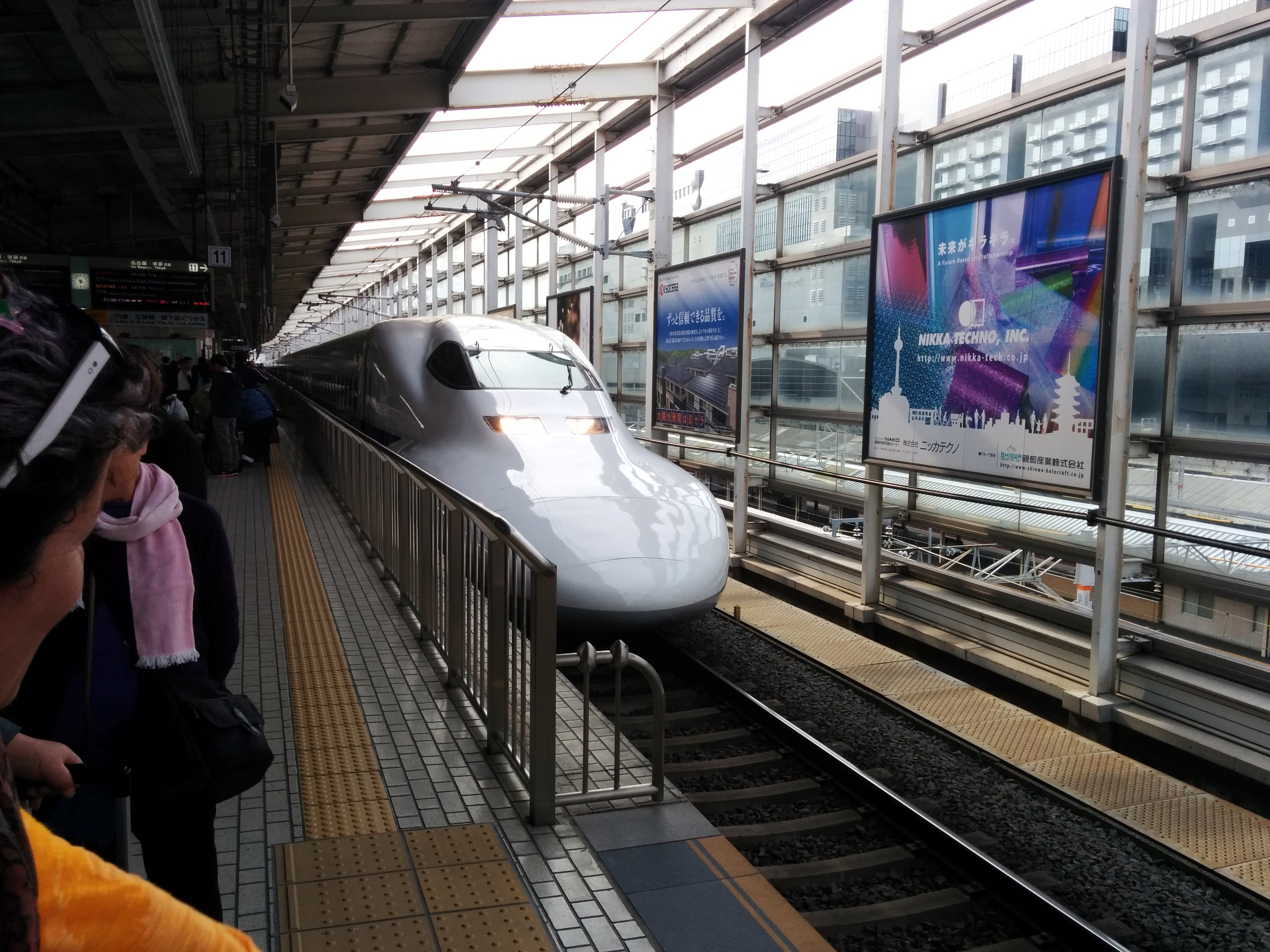 Shinkansen bullet train arriving at a Japanese station platform