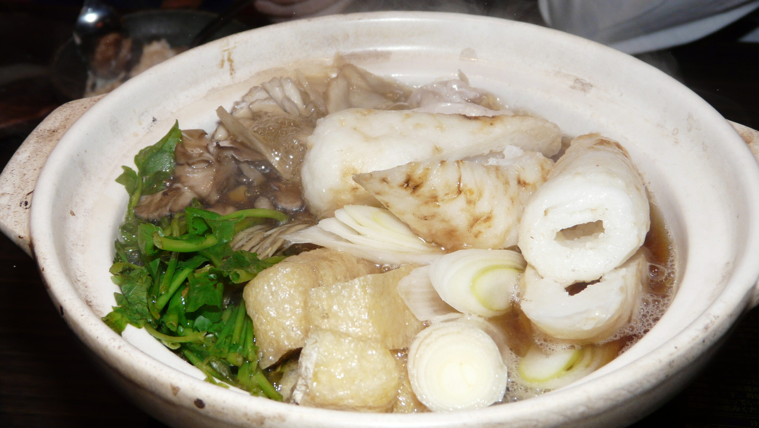 A completed kiritanpo nabe in a traditional clay pot