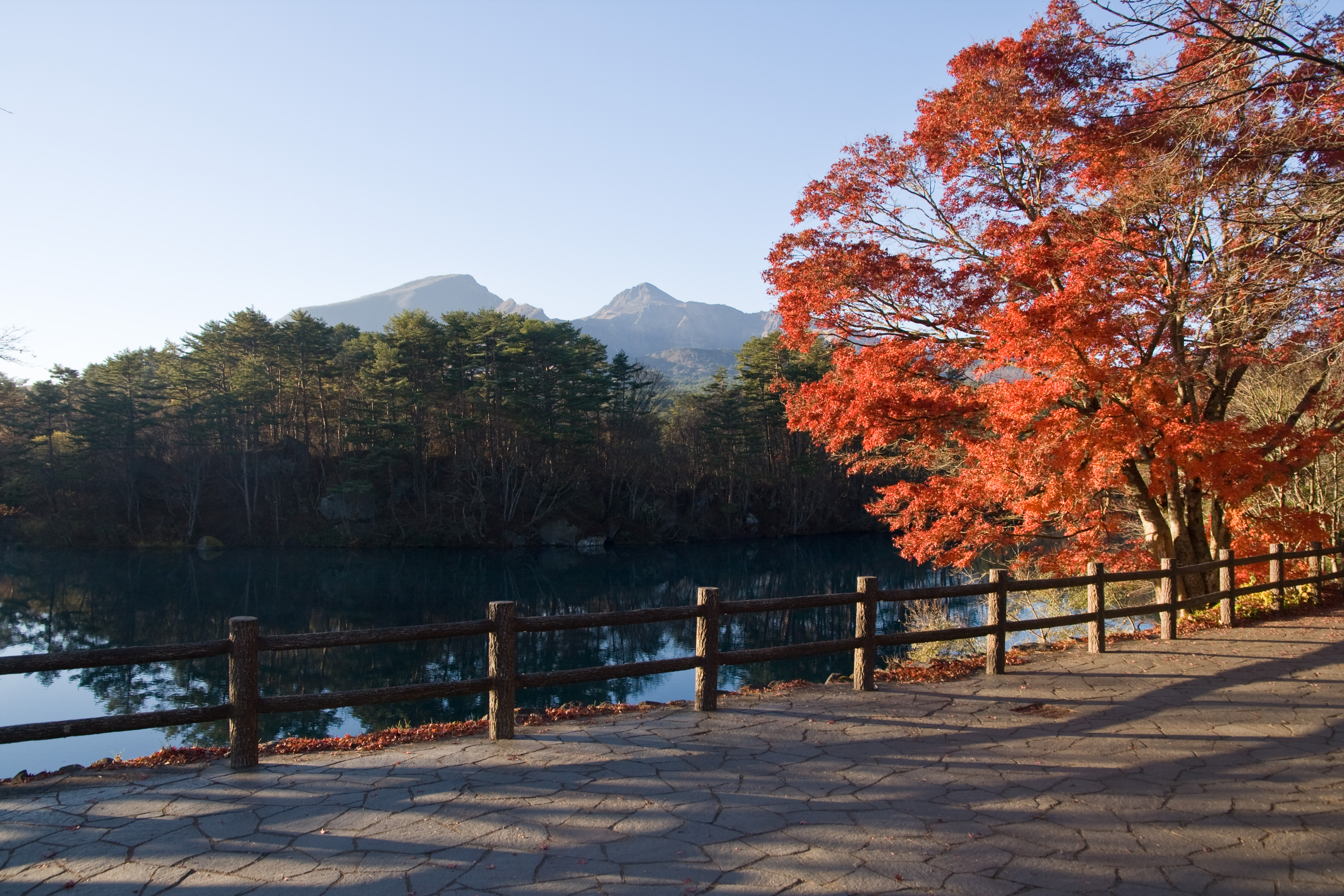 Mount Bandai volcano reflected in the calm waters of Goshikinuma lake