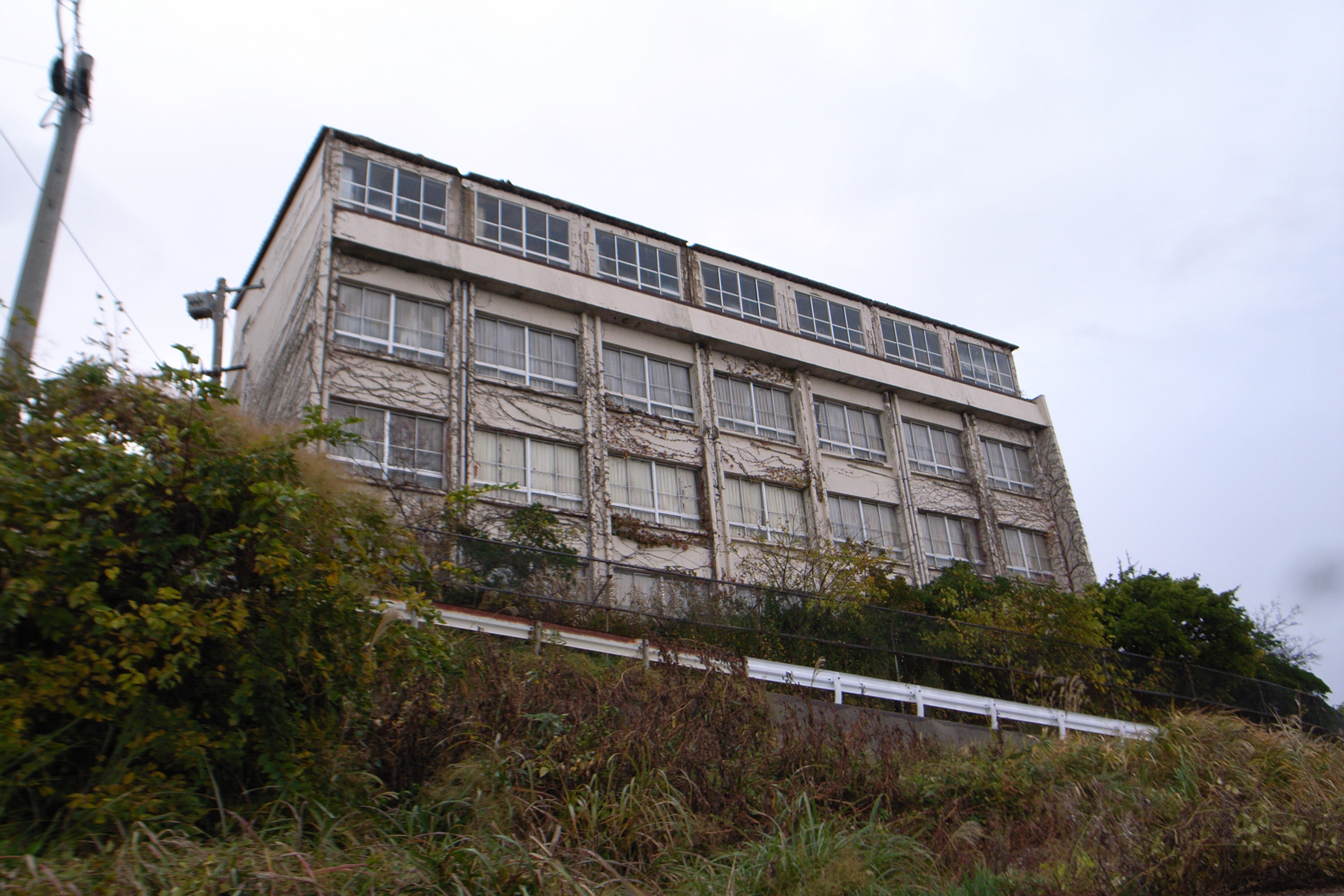 Interior of abandoned hotel showing decayed furnishings, natural light from broken windows