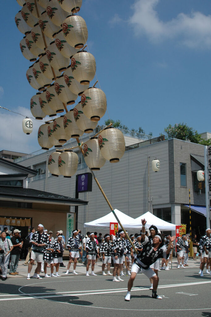 Akita Kanto festival lantern pole performance at night