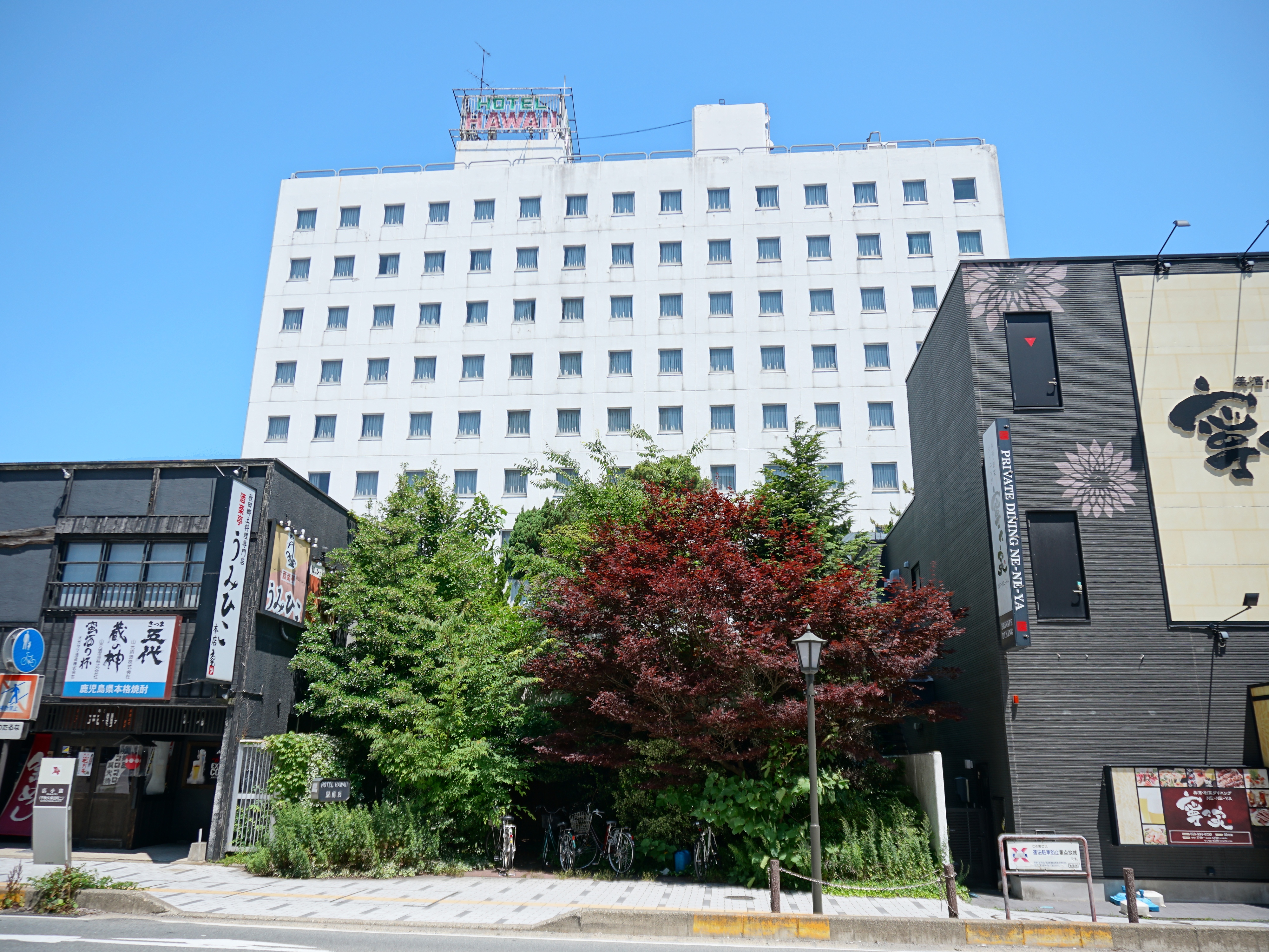 Ruins of Hotel Hawai near Akita Station showing overgrown exterior and abandoned structure