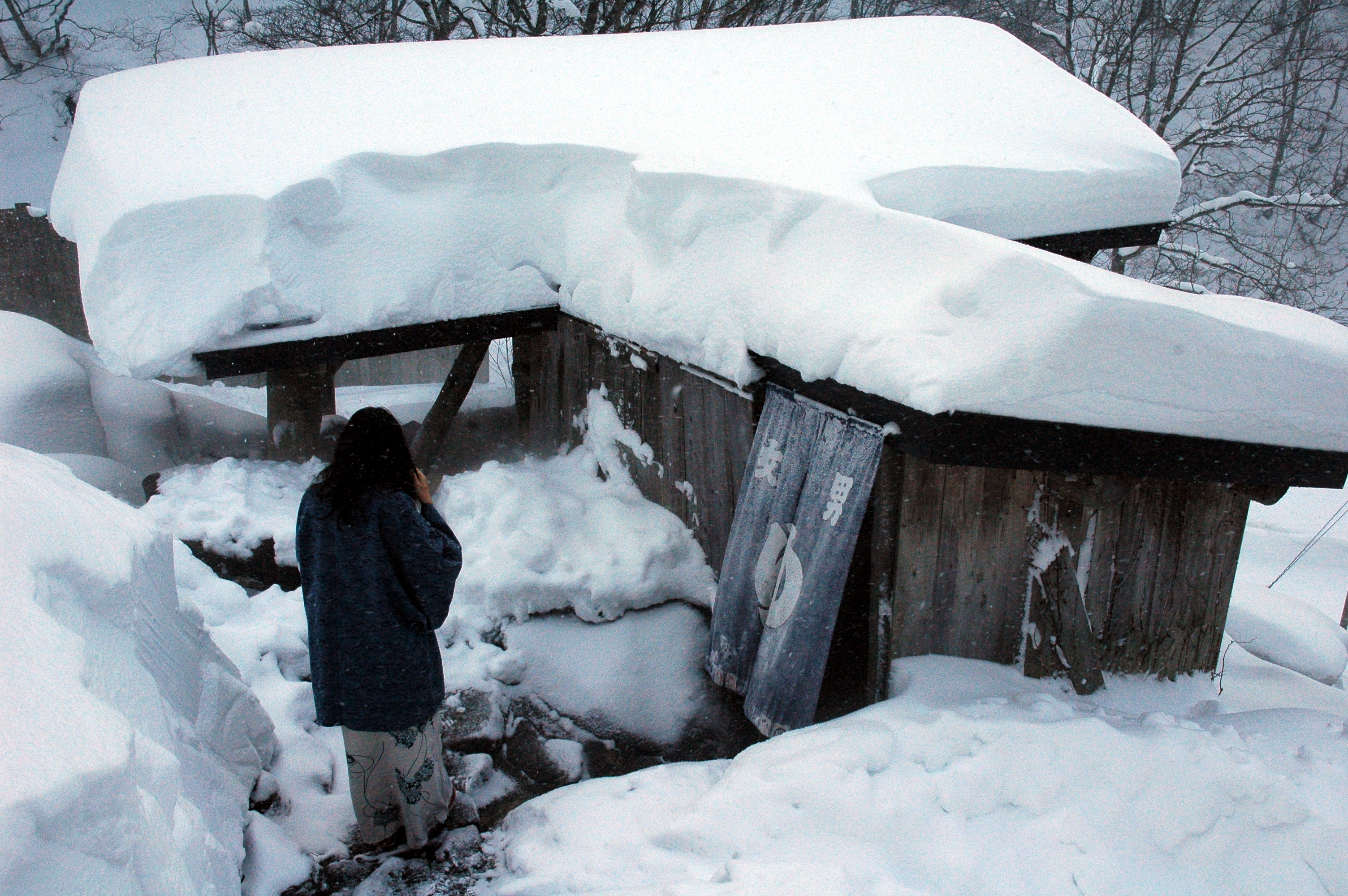 Outdoor rotenburo hot spring bath at a Japanese ryokan in winter