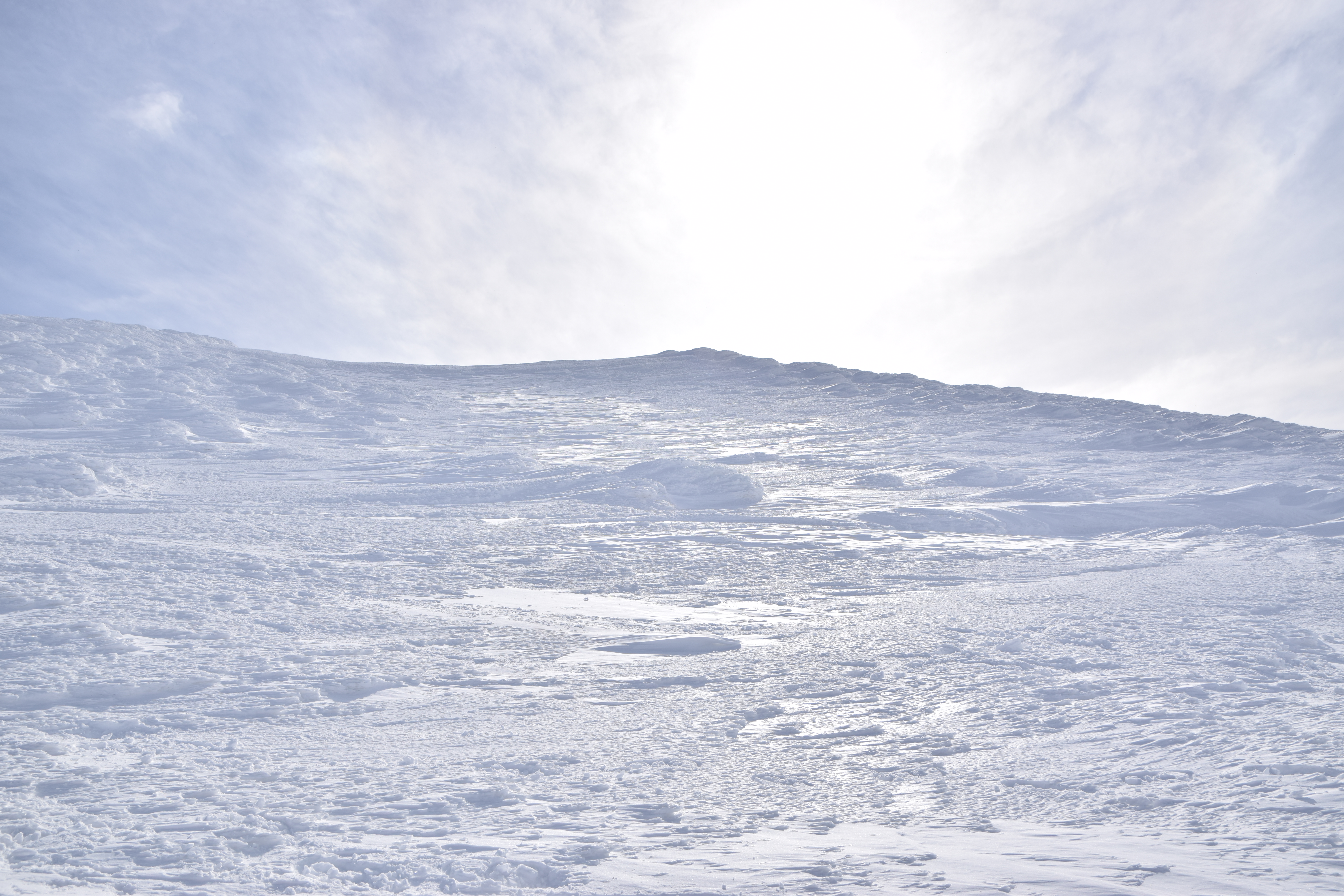 Winter hiking trail on Mount Zao with snowy landscape and wide sky views