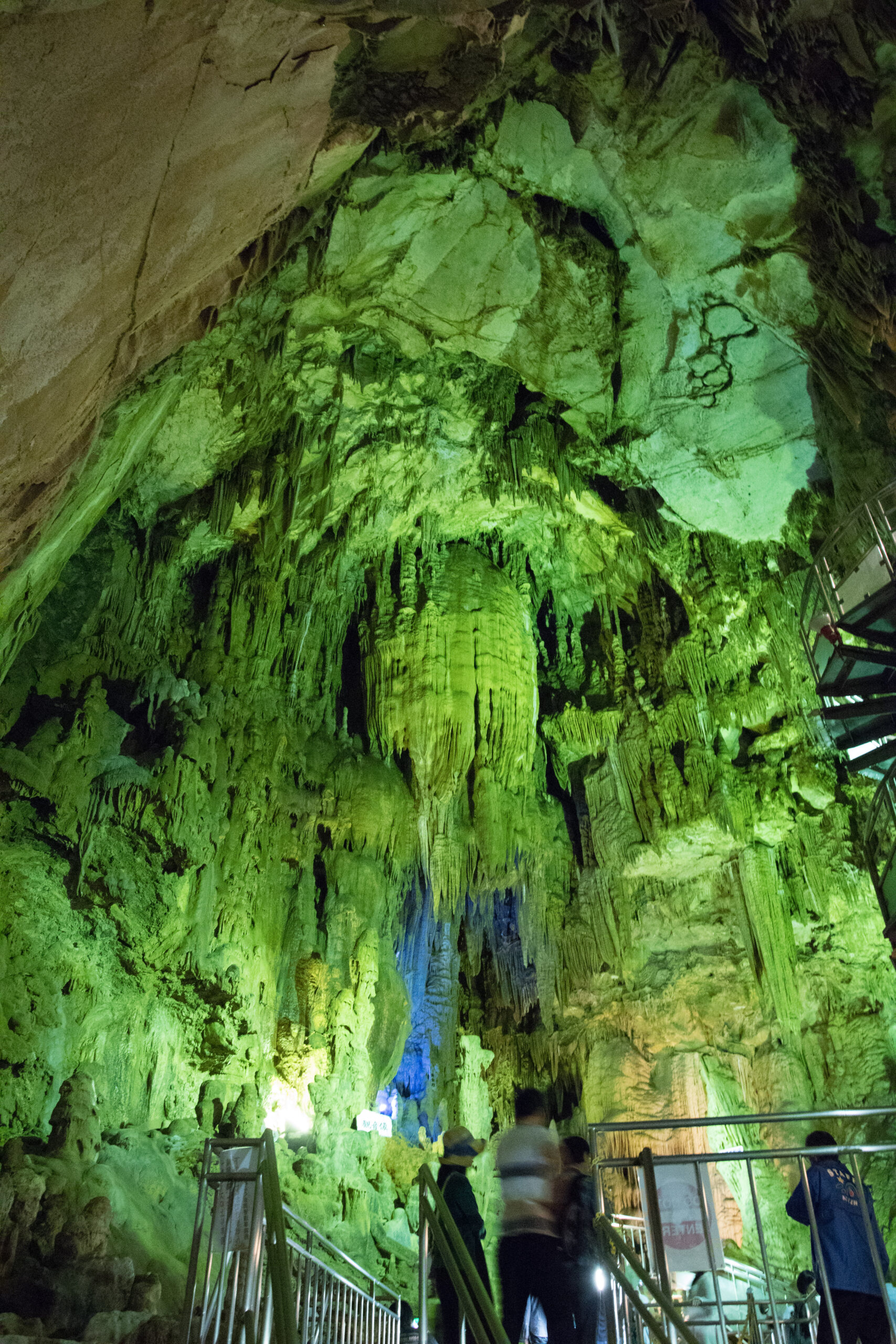 Large cave chamber with illuminated stalactites and stalagmites in Abukuma Cave