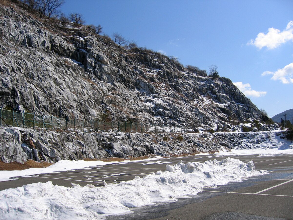 The dramatic limestone outcrop above Abukuma Cave entrance, showing the geological formation of the Abukuma Highlands