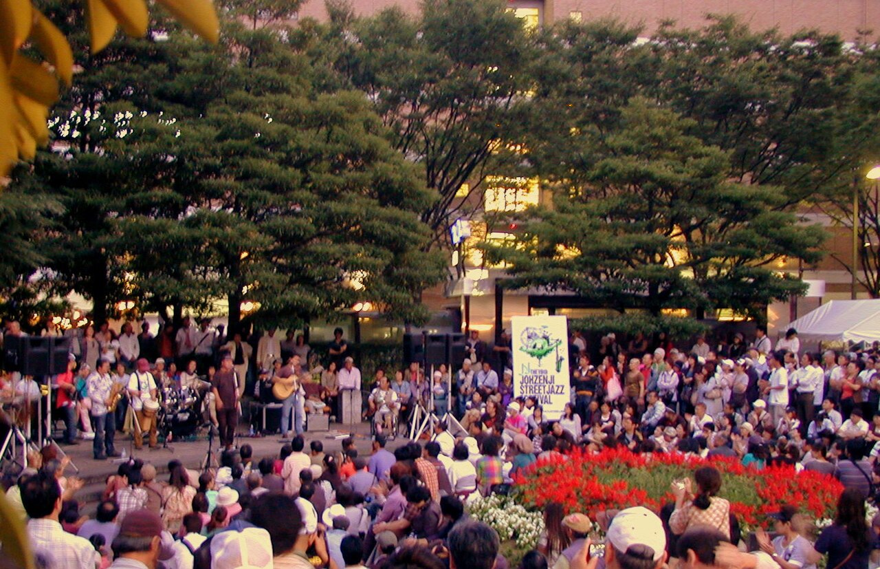 Outdoor stage performance at Sendai's Jozenji Street Jazz Festival under zelkova trees