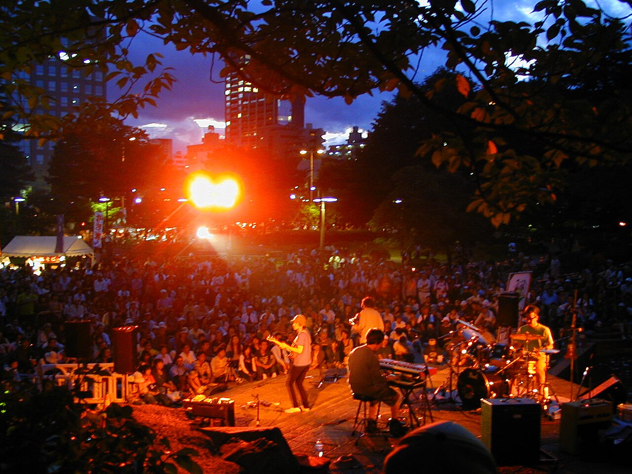 Crowd enjoying performances at the Jozenji Jazz Festival along tree-lined avenue in Sendai