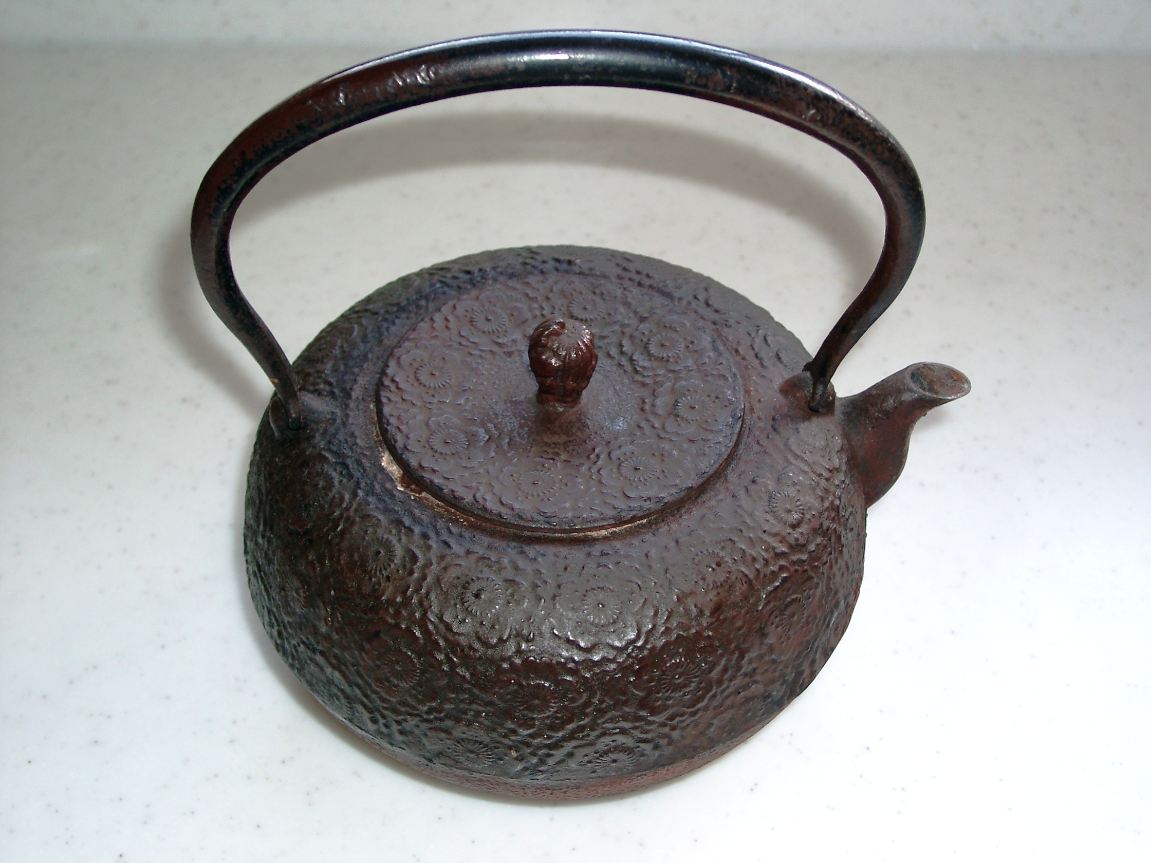 Classic Nanbu Tekki tetsubin iron kettle with traditional arare dot pattern finish