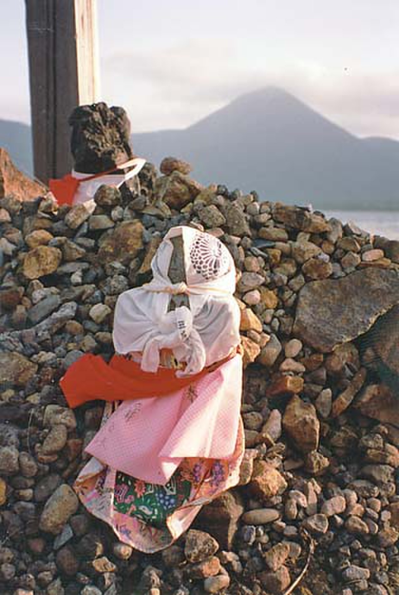 Jizo statues with red bibs and offerings at Osorezan, representing souls of deceased children