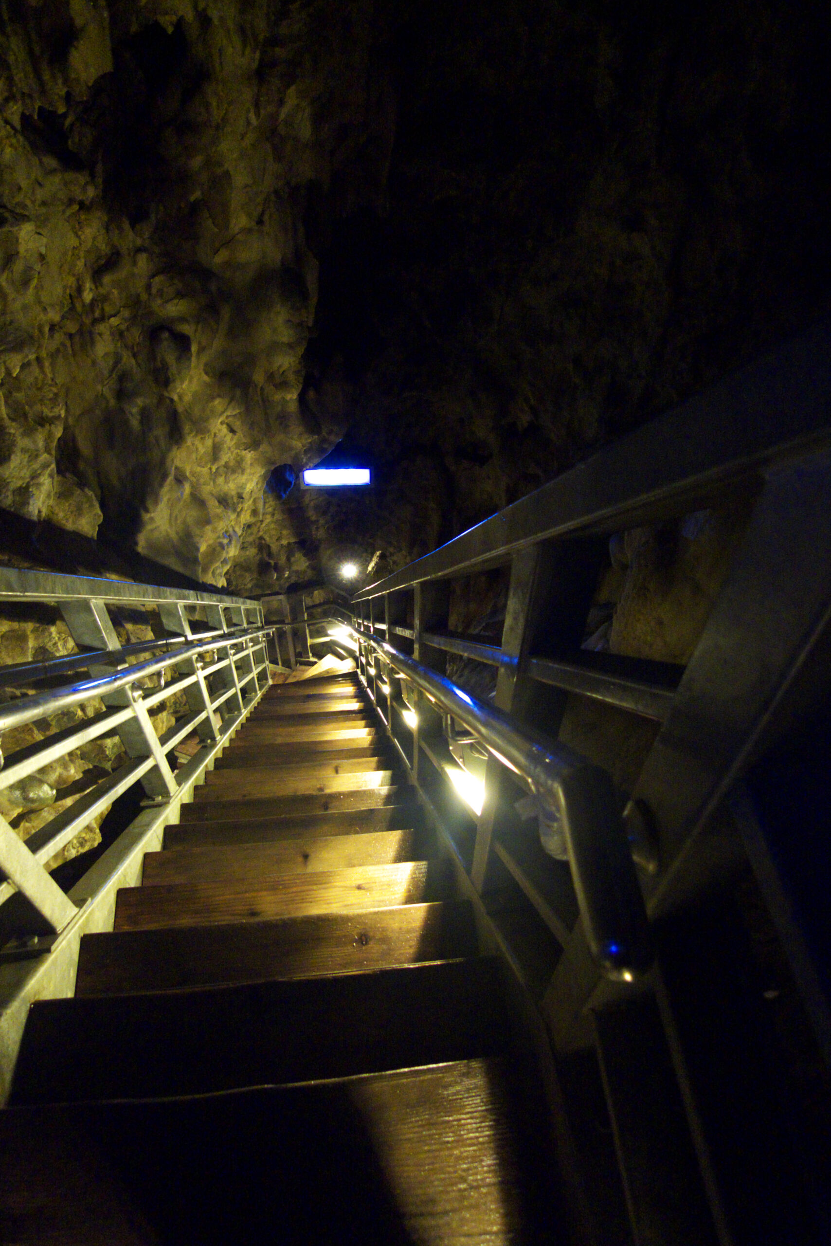 Wooden walkways and stairs inside Ryusendo Cave leading deeper underground