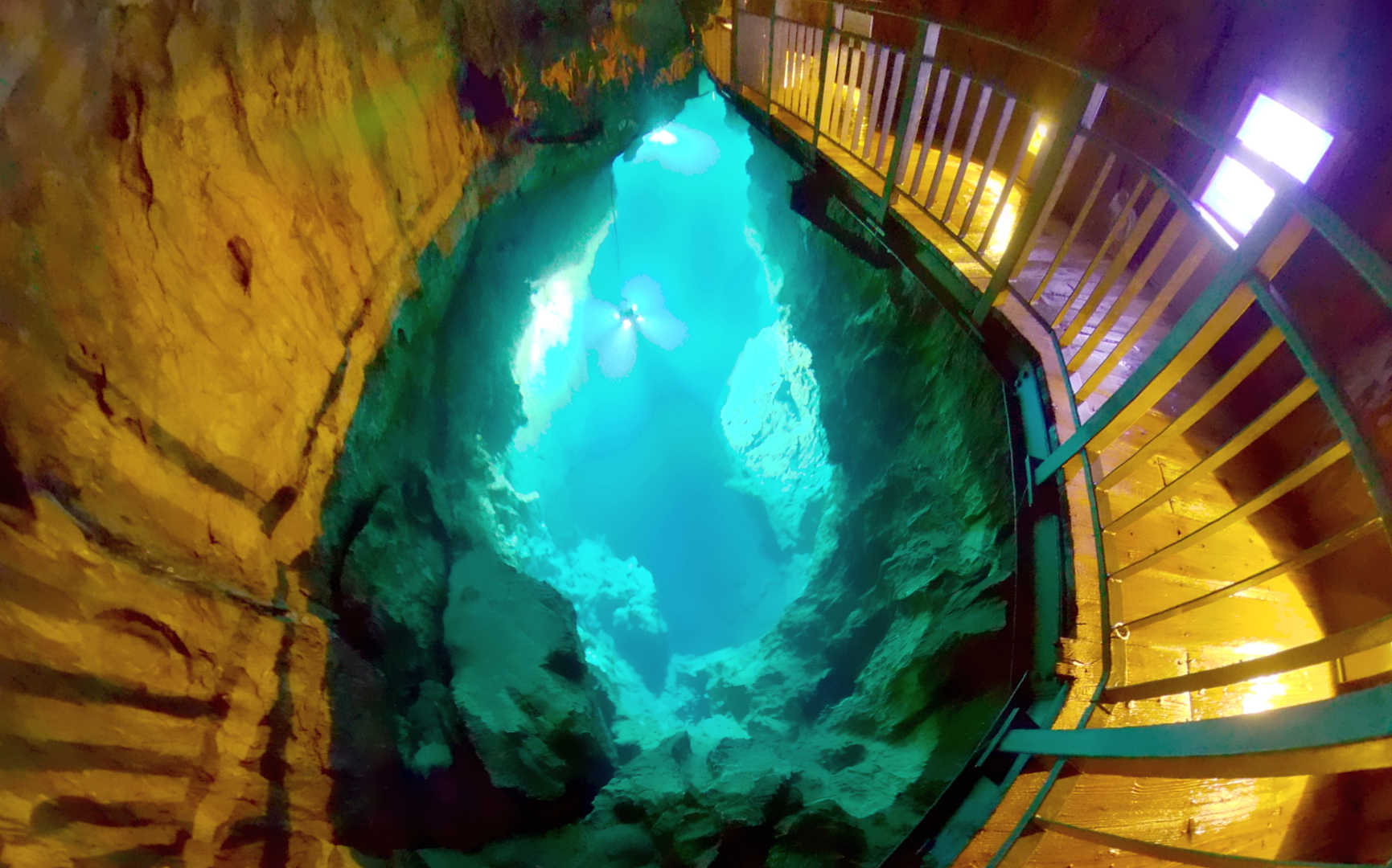 Crystal-clear underground lake inside Ryusendo Cave lit dramatically