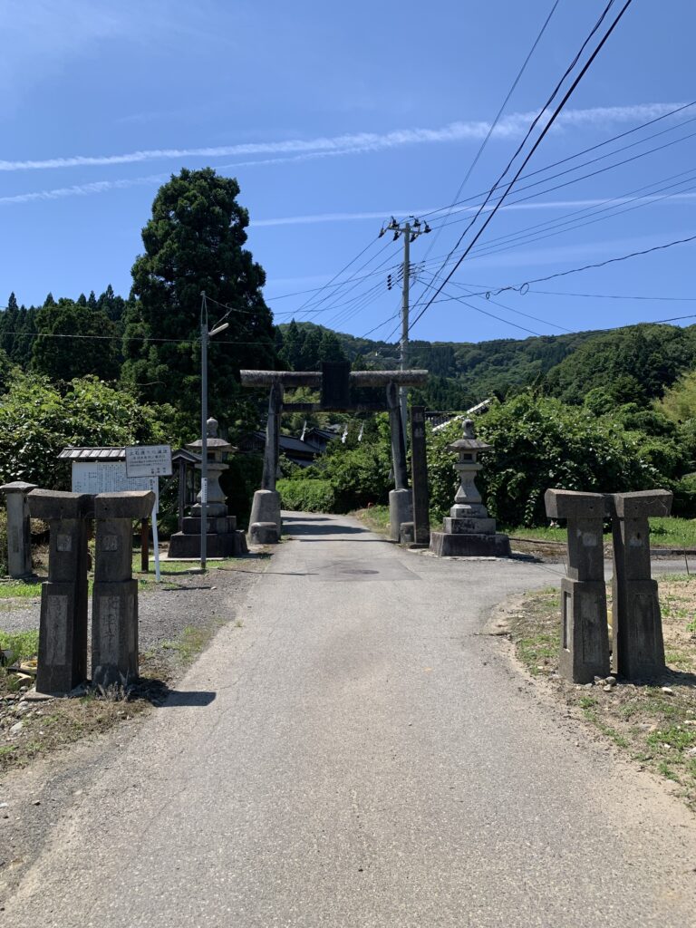 Arakura Jinja Shrine in Tsuruoka with traditional stone torii gate and steps leading through a forested approach