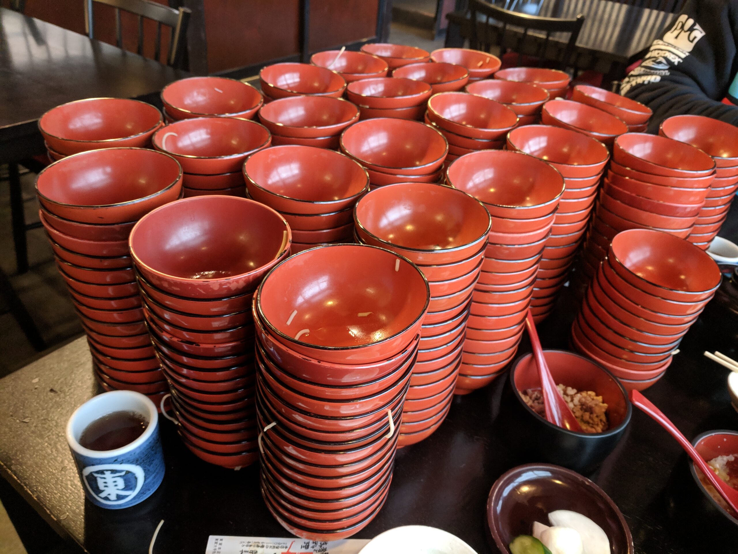 Stack of wanko soba lacquered bowls counting the servings eaten