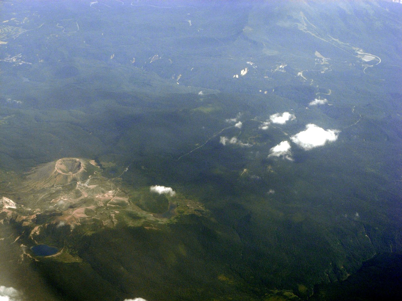 Azuma-Kofuji volcano crater rim with grey sulphurous rocks and blue sky above