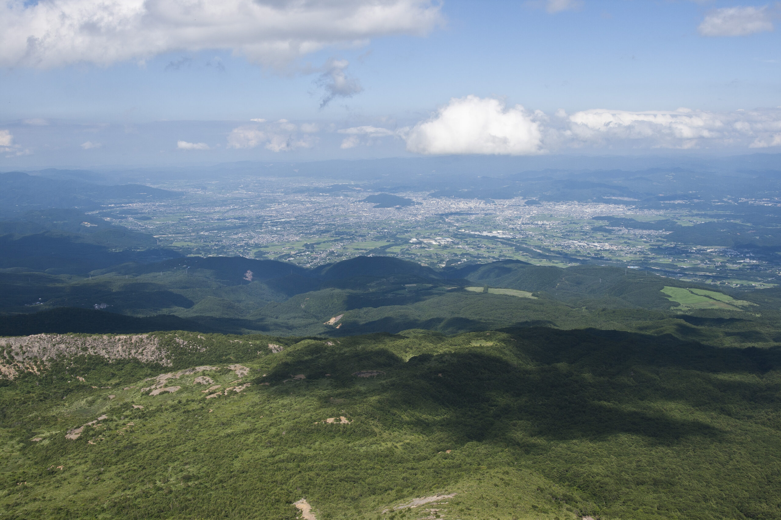 Panoramic view of Fukushima basin and city spreading across the wide valley from Azuma-Kofuji summit