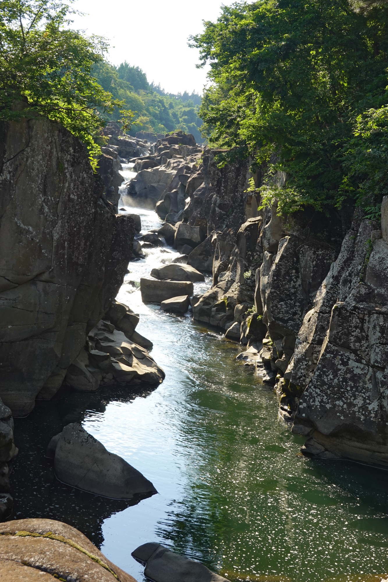 Scenic view of Genbikei Gorge river and rocky cliffs in Iwate