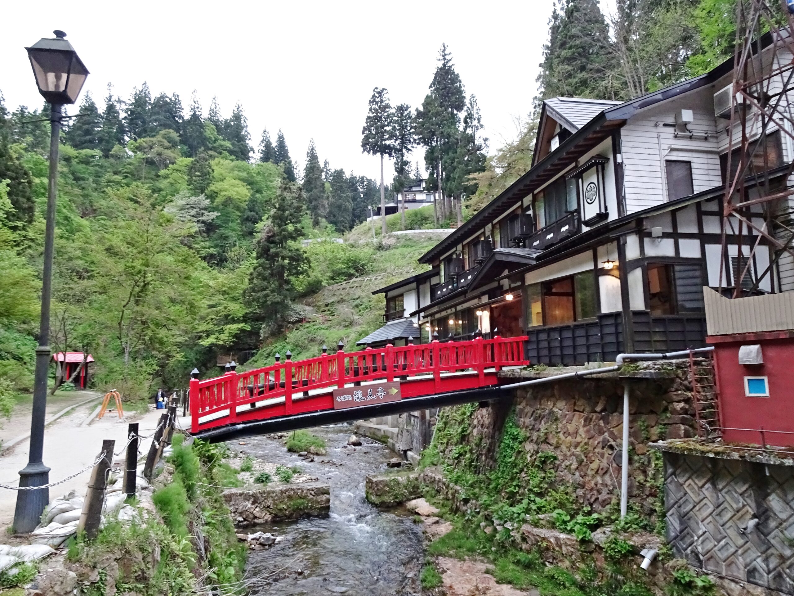 Takimi Bridge at Ginzan Onsen with traditional buildings visible in the background