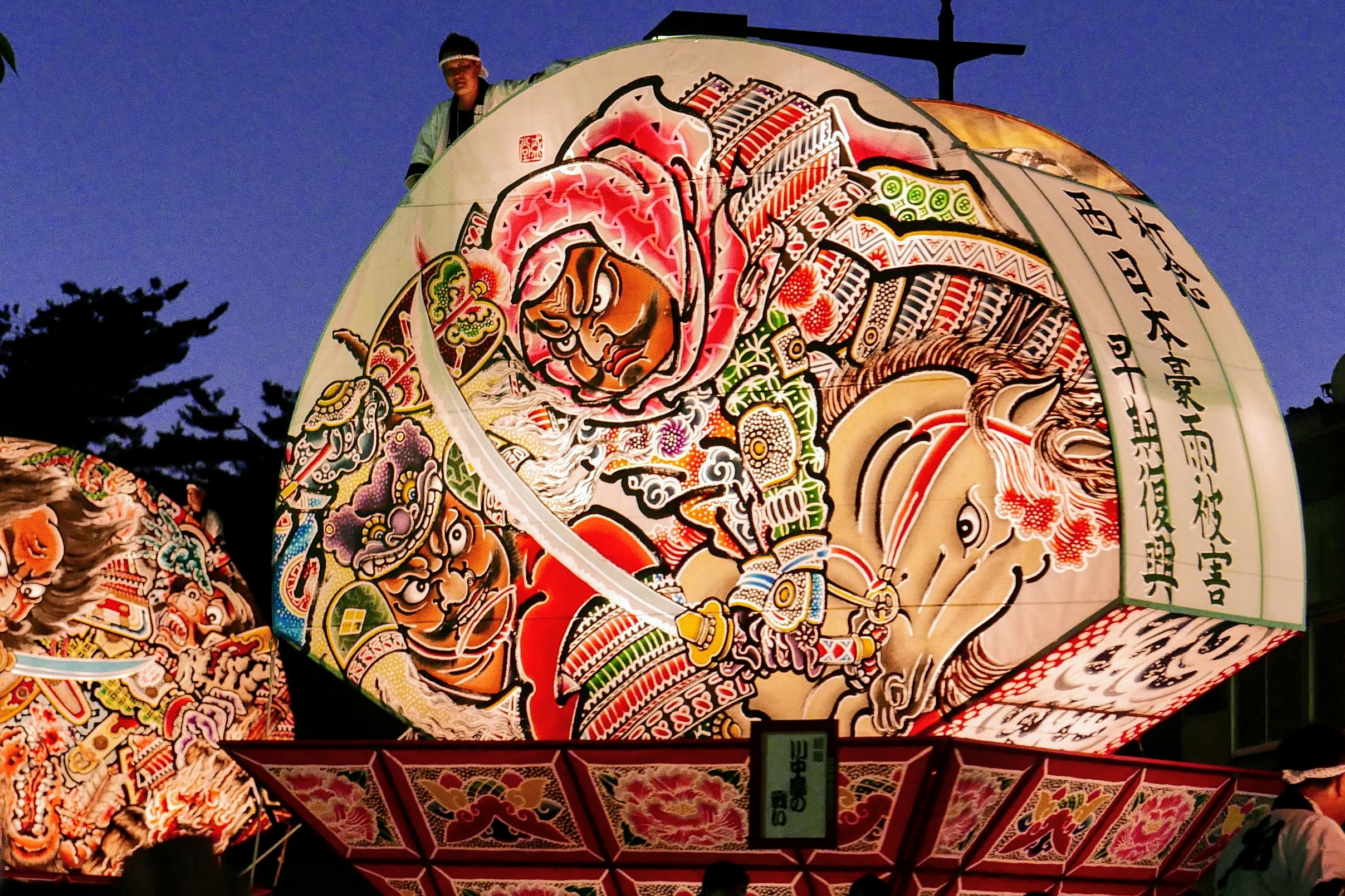 Giant fan-shaped Neputa float illuminated during Hirosaki Neputa Festival