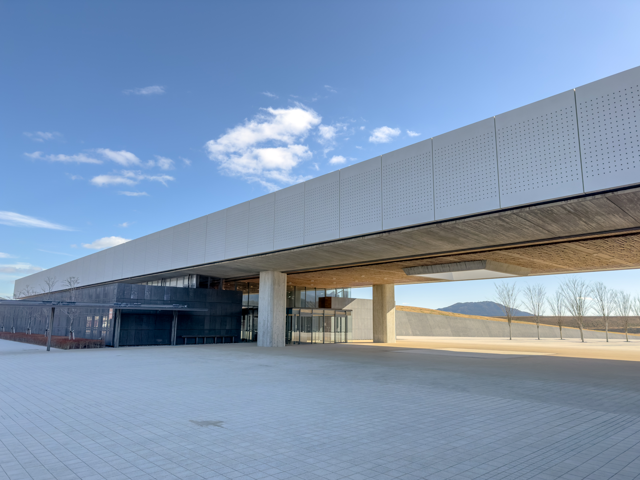 The Iwate Tsunami Memorial Museum building exterior in 2023, a modern architectural structure amid green landscape