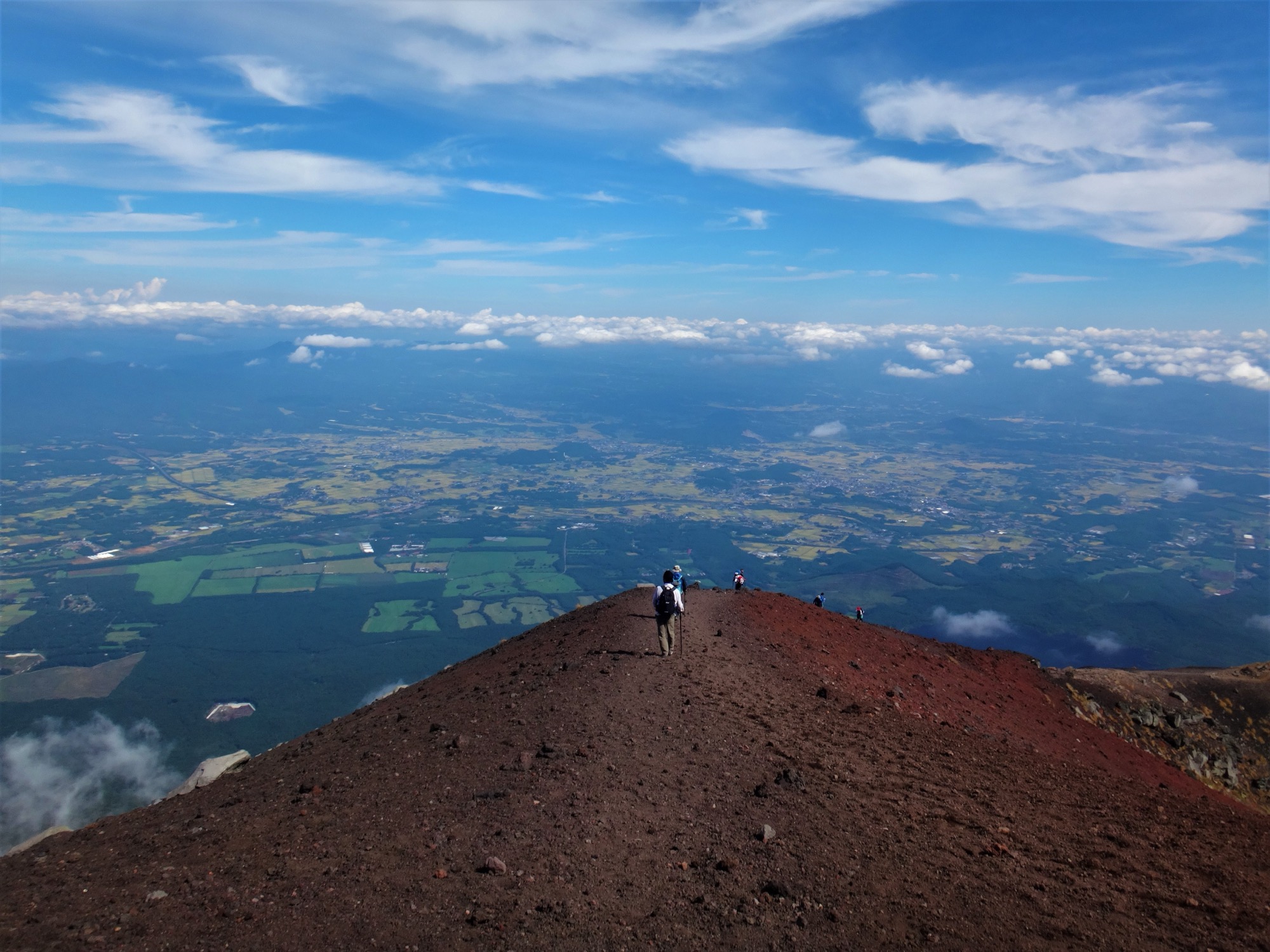 Hikers walking along the crater rim of Mount Iwate in Iwate Prefecture, Japan