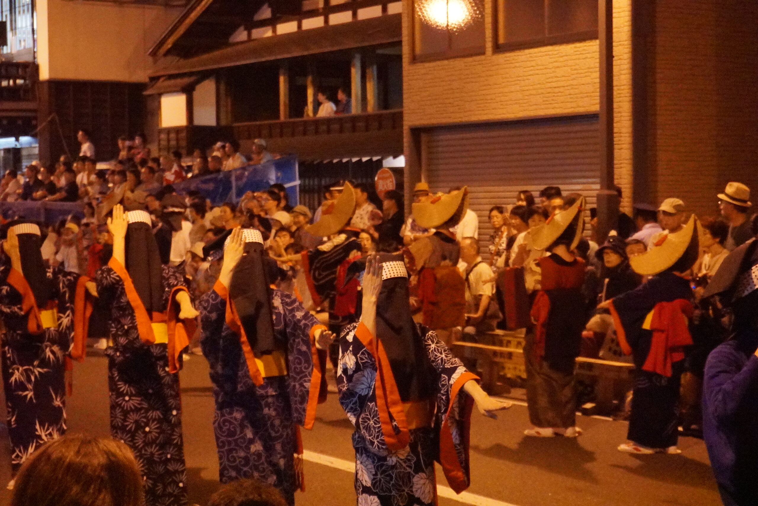 Night view of Nishimonai Bon Odori festival procession with lanterns and crowd