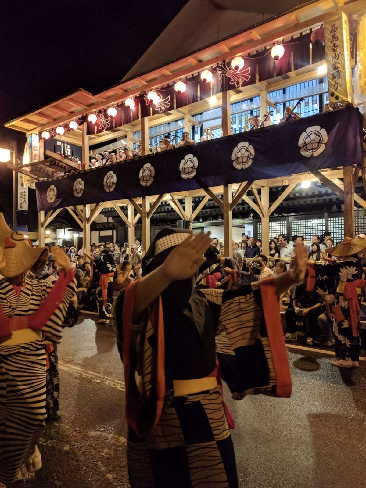 Close view of Nishimonai Bon Odori dancers showing the hikosa-zukin black hood costume