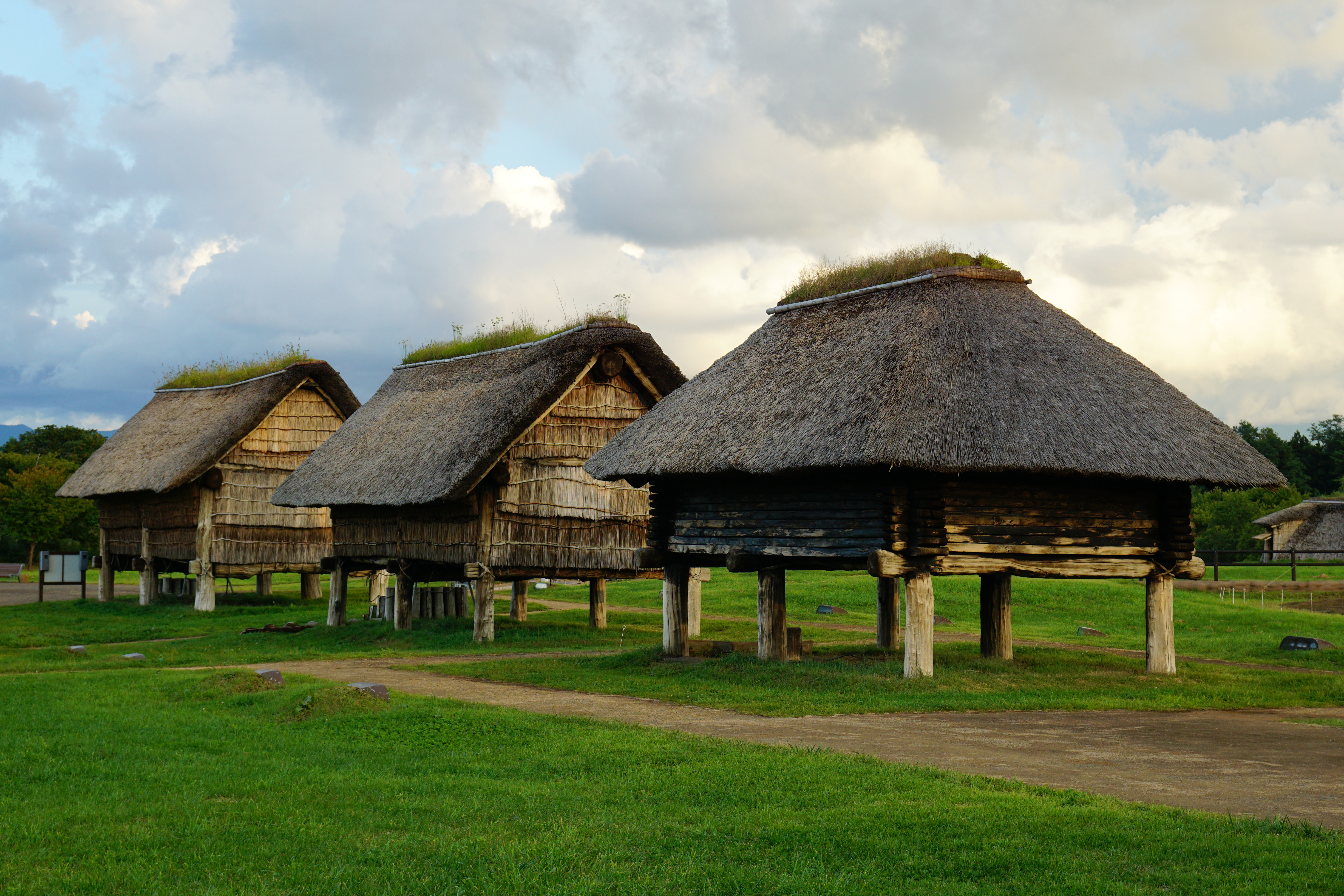 Reconstructed longhouse and pit dwellings at Sannai-Maruyama archaeological site in Aomori