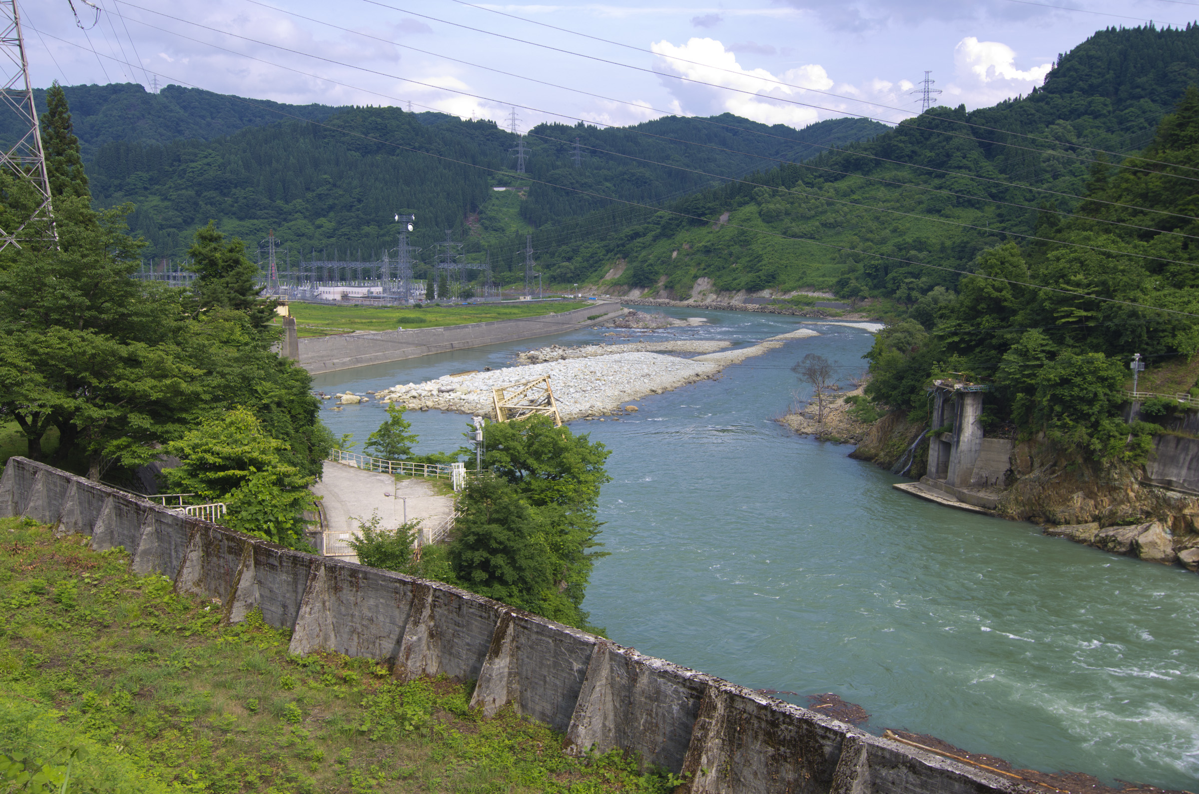 The Tadami Line train passing through rural Fukushima countryside with green rice paddies