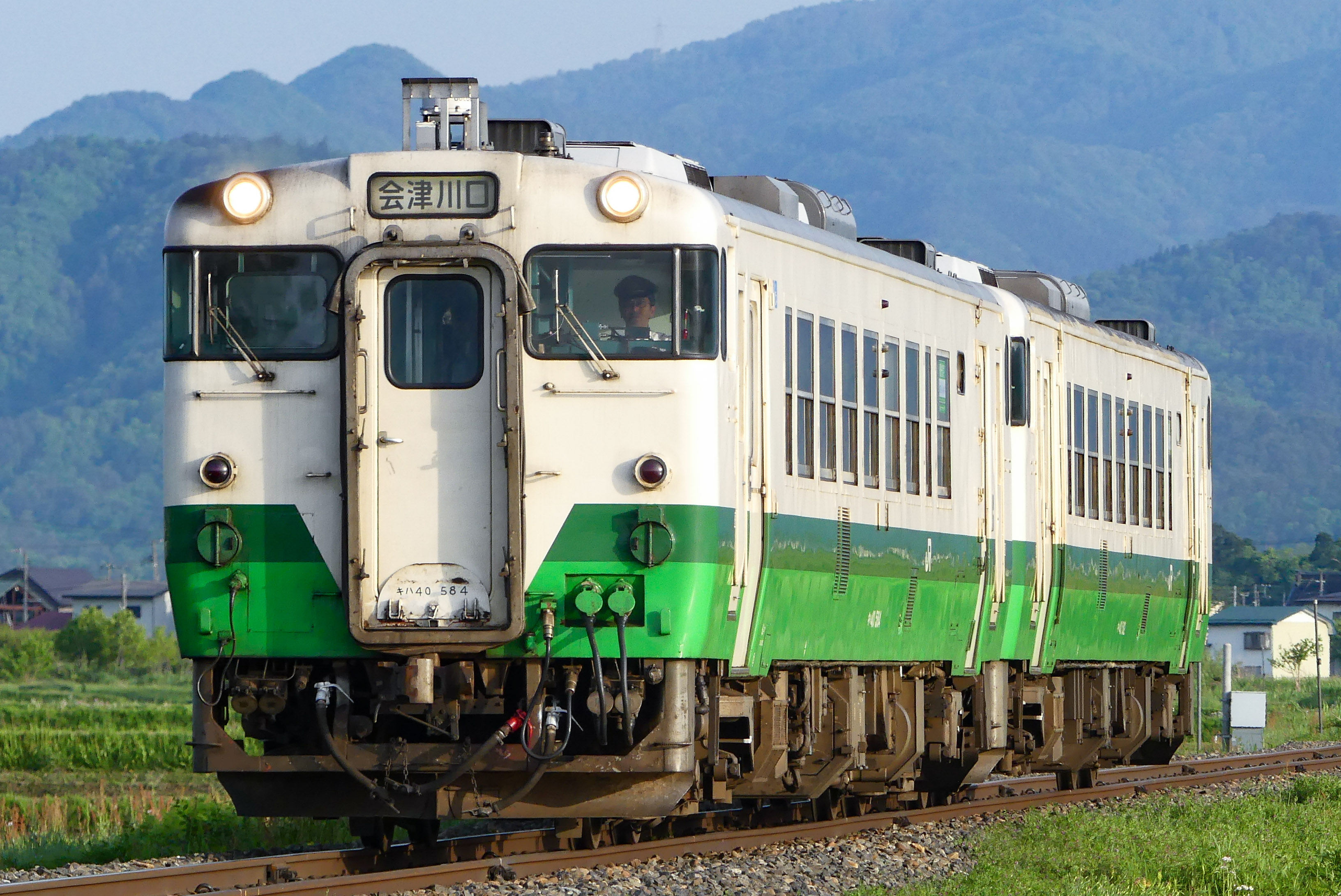 The Tadami Line KiHa-40 diesel multiple unit train at a rural station in the mountains