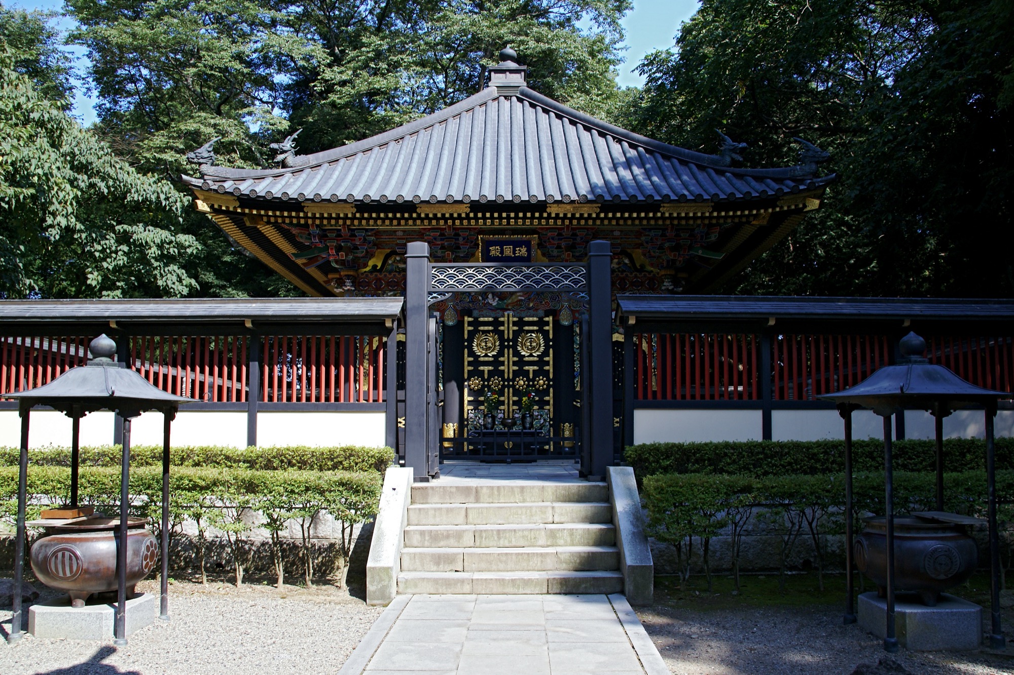 Interior view of ornate carvings and woodwork inside the Zuihoden complex