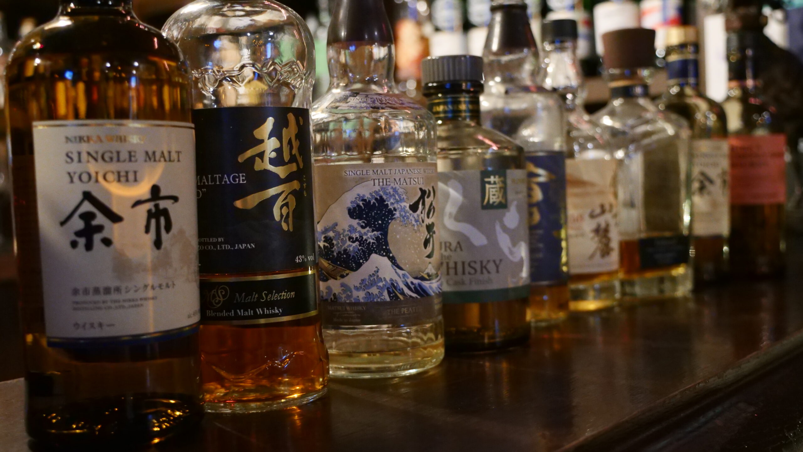 A glass of Japanese whisky with ice, showcasing its golden amber color
