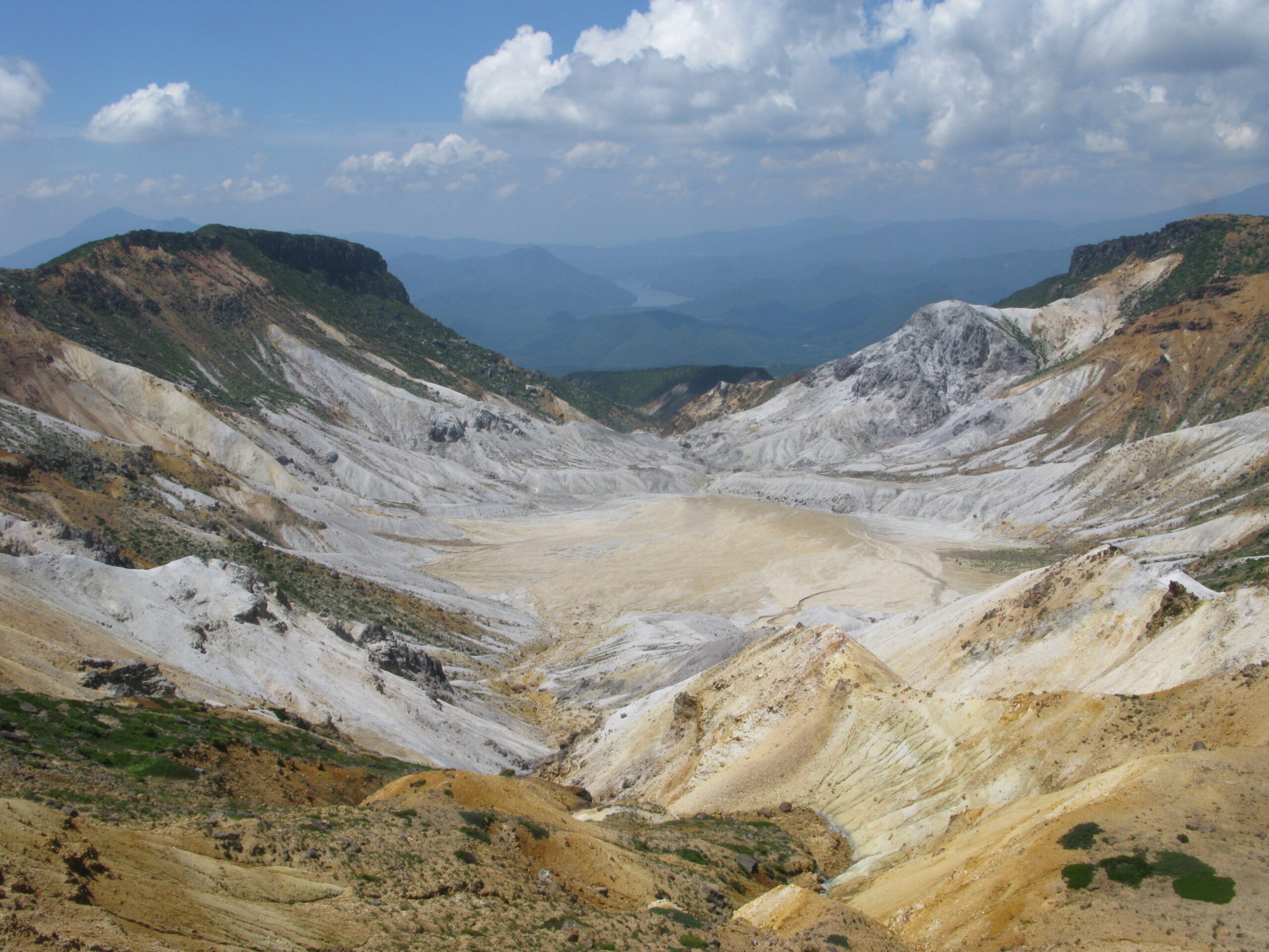 Numanotaira volcanic crater on Mount Adatara with sulfur-streaked rock walls